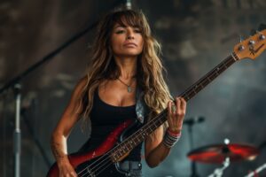 Portrait of a female musician playing bass guitar on stage